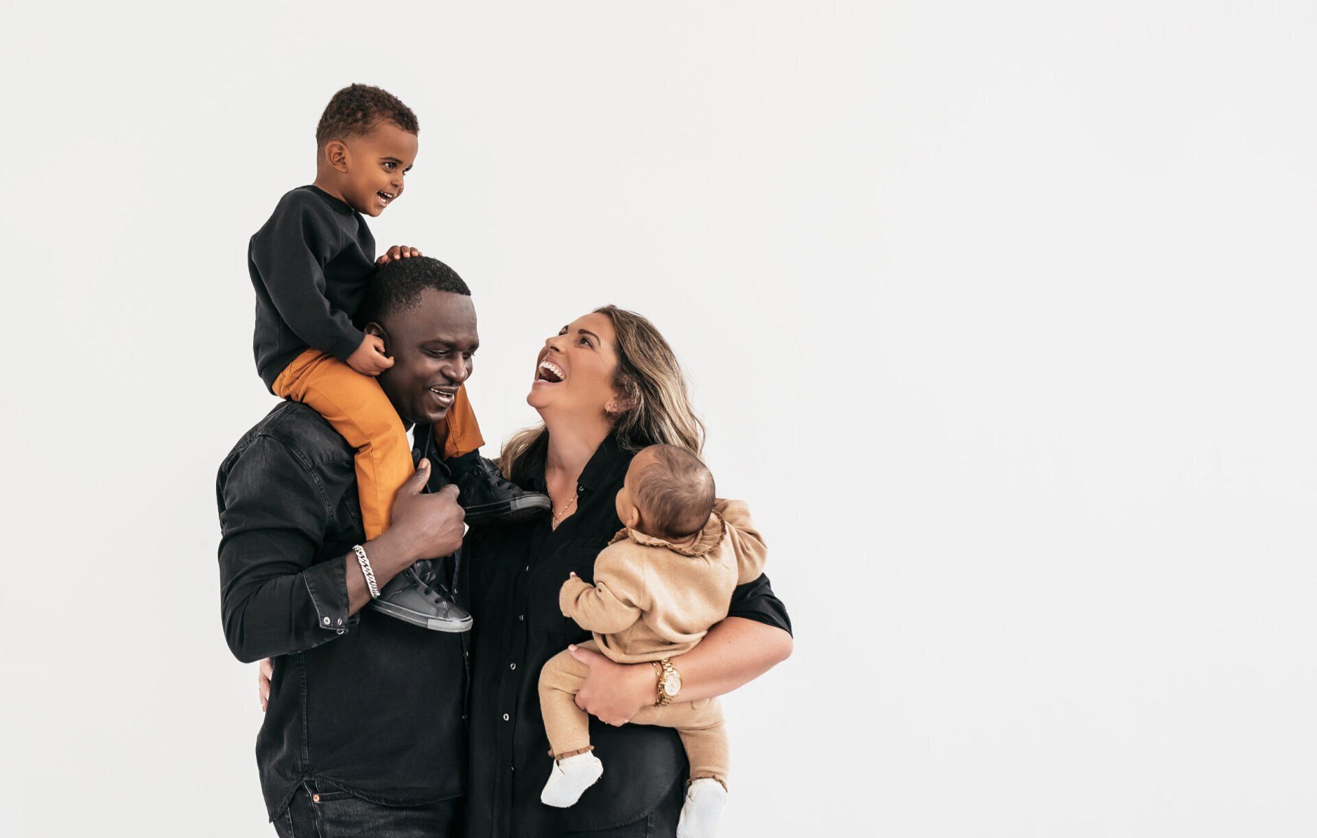 Photo of a parents holding their two children while  embraced for toronto gift idea