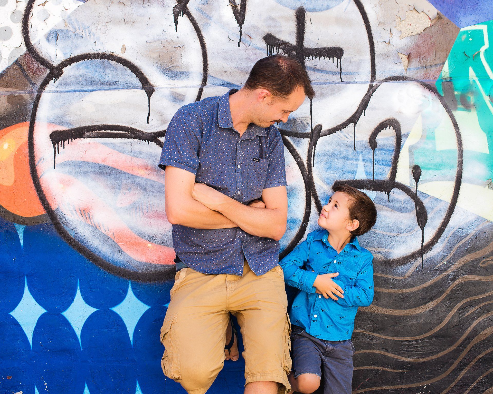 Lifestyle photography Toronto | Stacey Naglie | Man and boy standing in front of graffiti covered wall