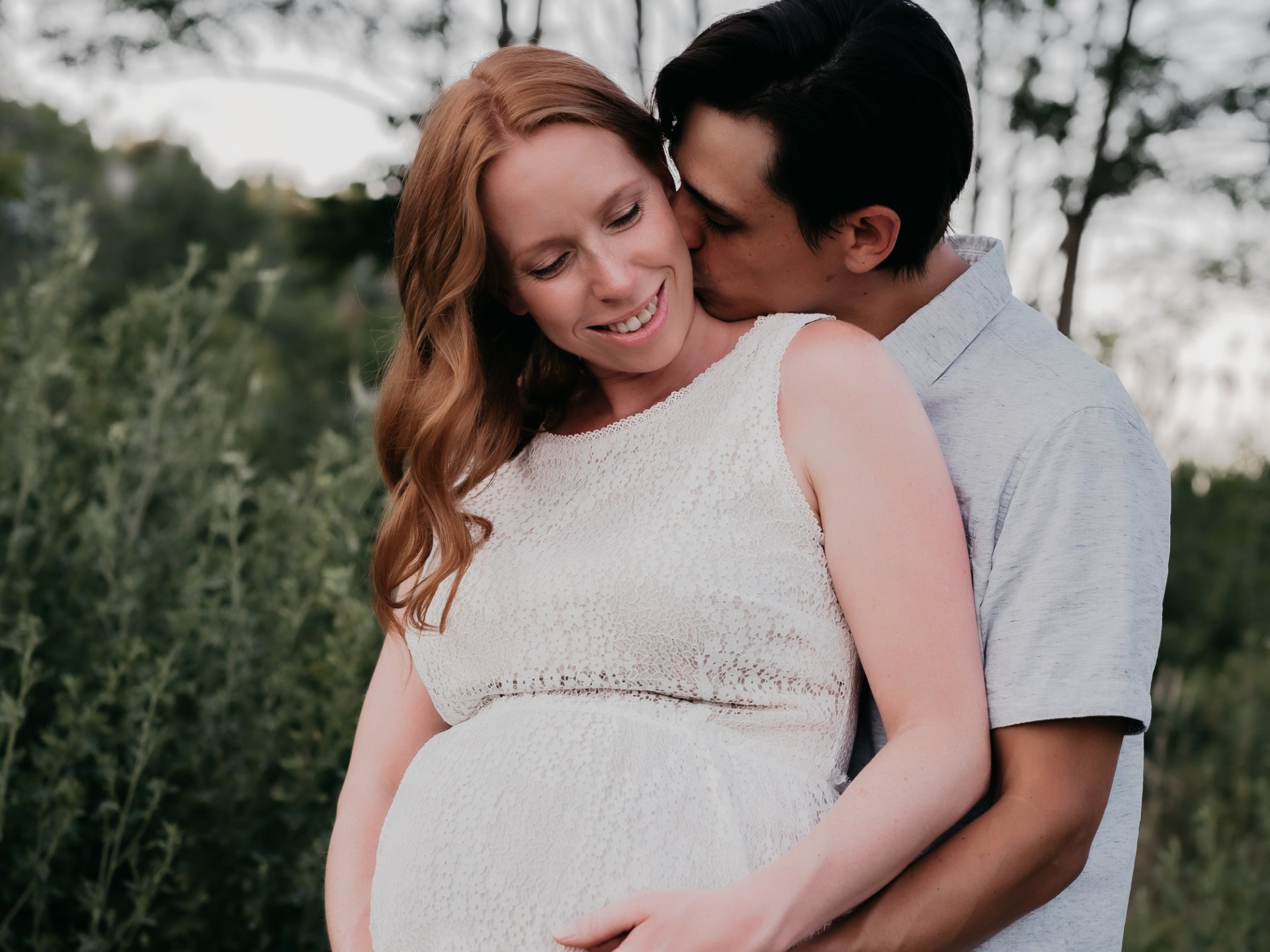 Photo of a pregnant wife embraced by husband for maternity photography