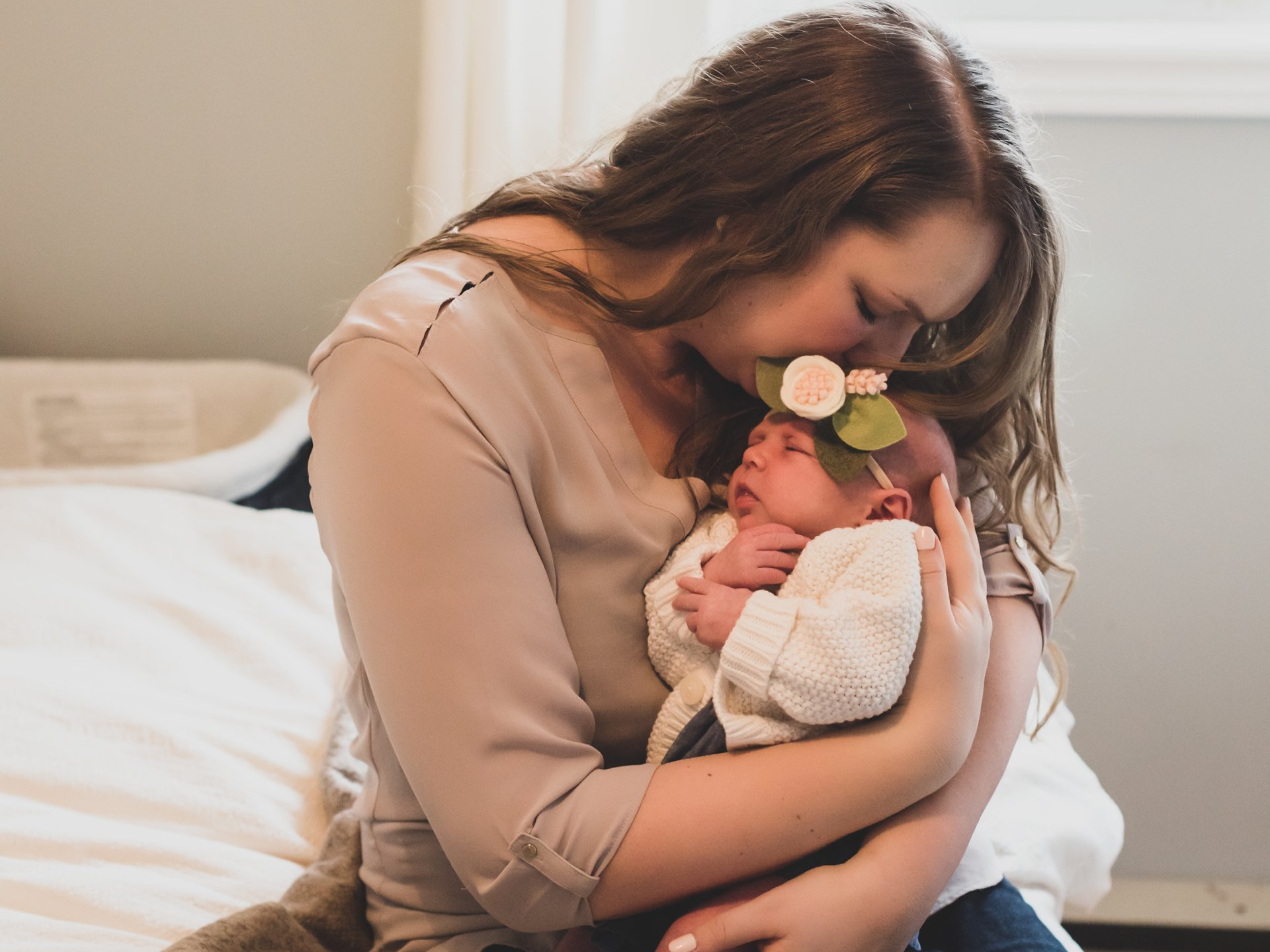 A photo of mom embracing a small baby girl for maternity and newborn photography