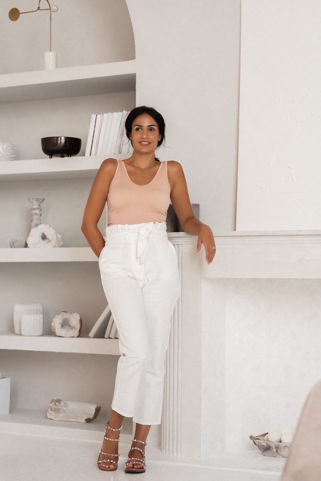Branding photo of social media influencer Chantel wearing a beige top posing in white themed living room