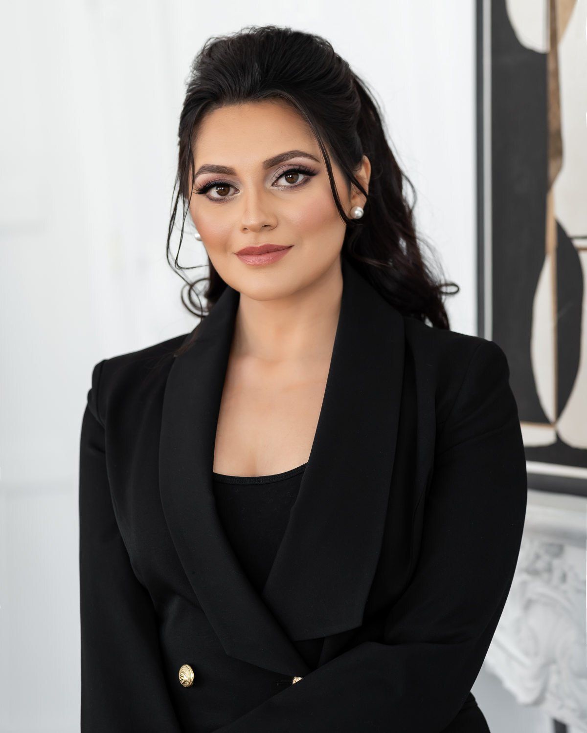 Female business executive standing against a wall for personal branding photography