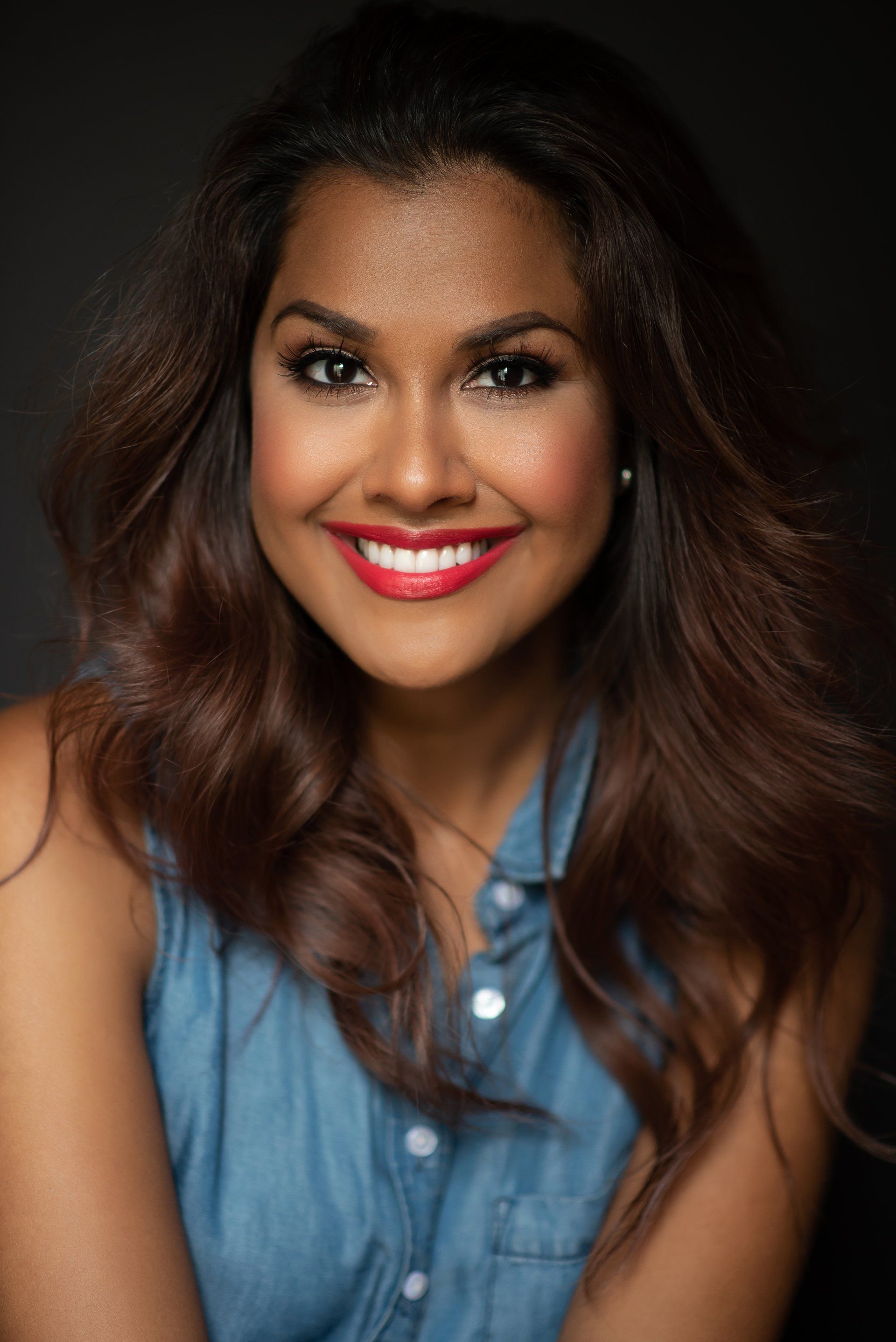 a casual photo a woman with brown hair wearing blue top