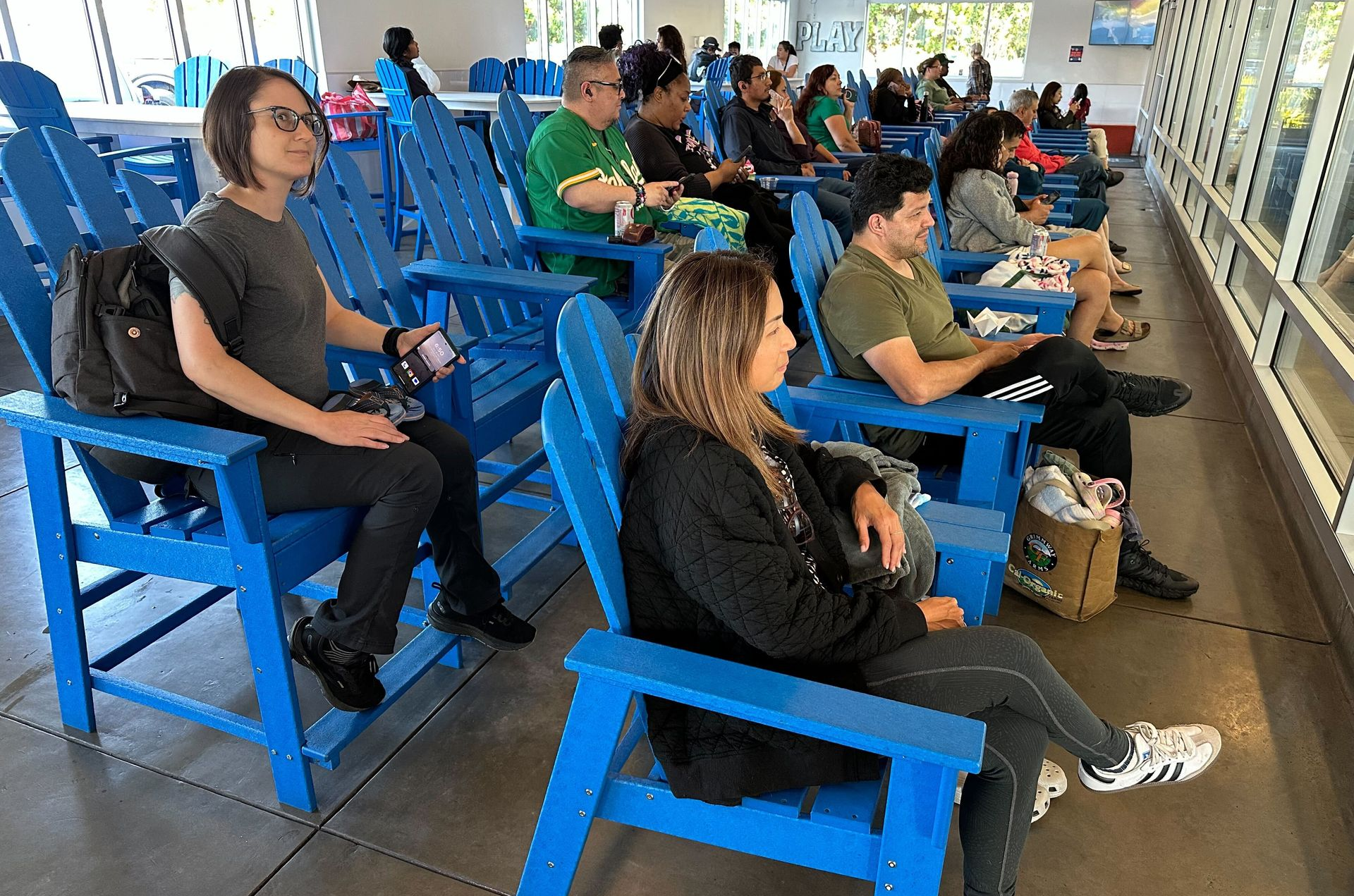 A woman is talking to a young girl in a swimming pool.