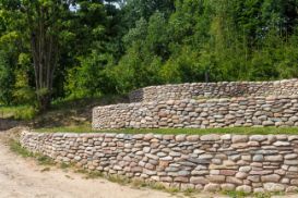 Newly built concrete retaining wall covered with stones as design - work by the expert concrete contractor in Wanneroo WA.