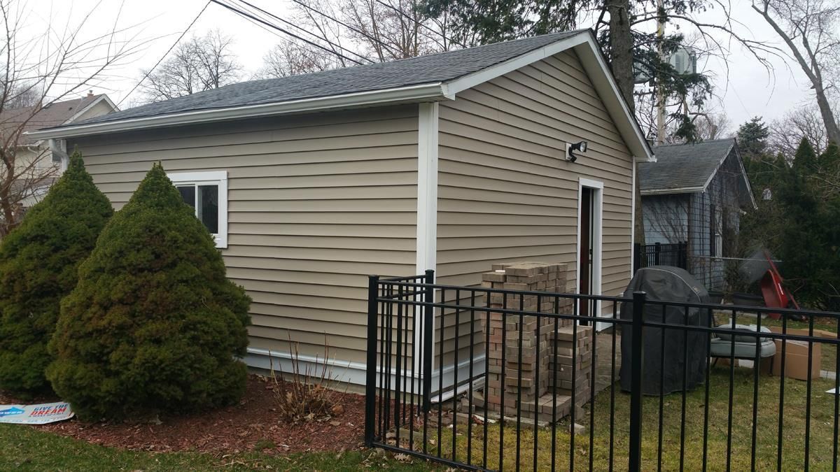 A small house with a fence in front of it.
