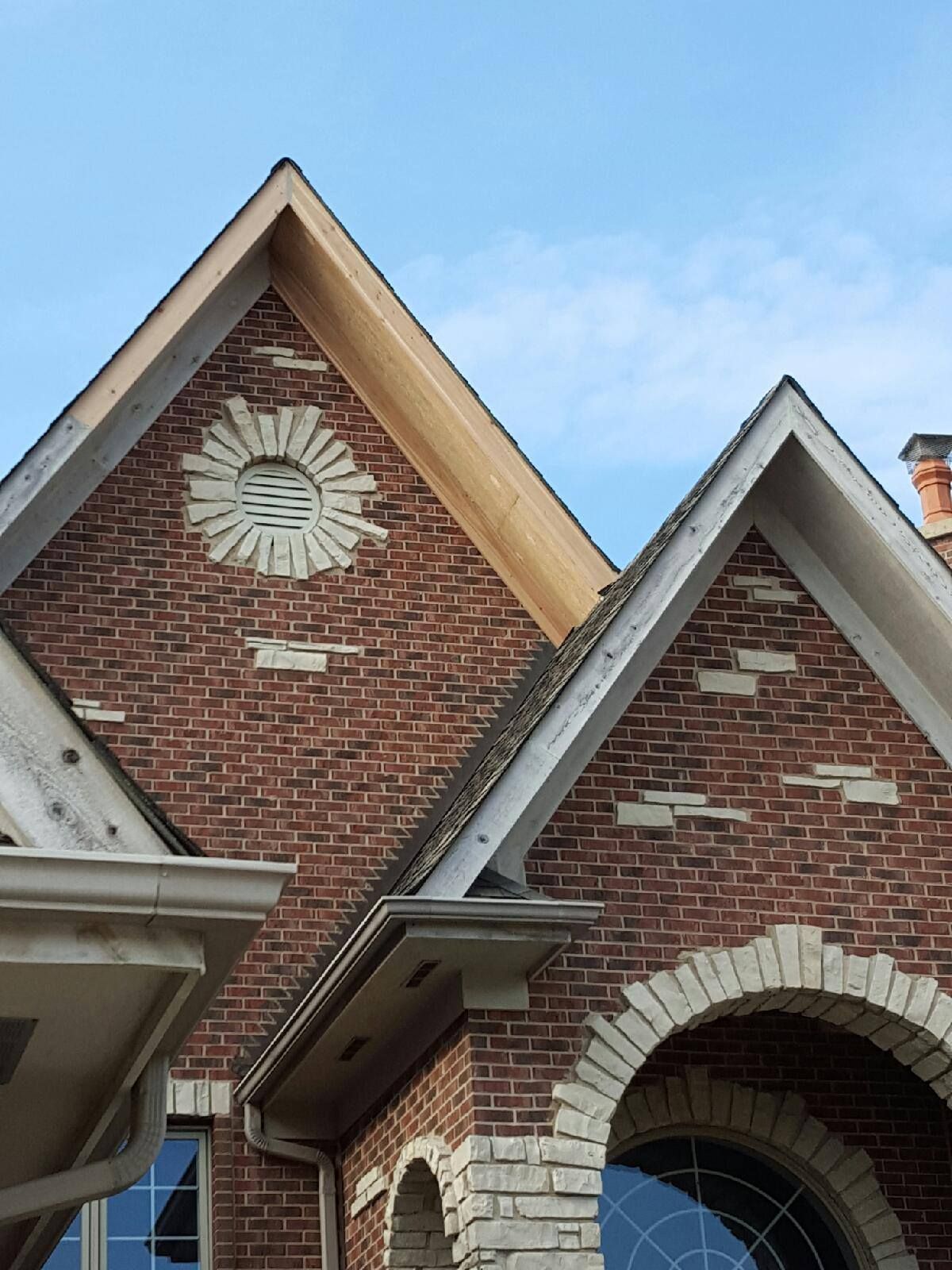 A brick building with a roof that has a sun on it