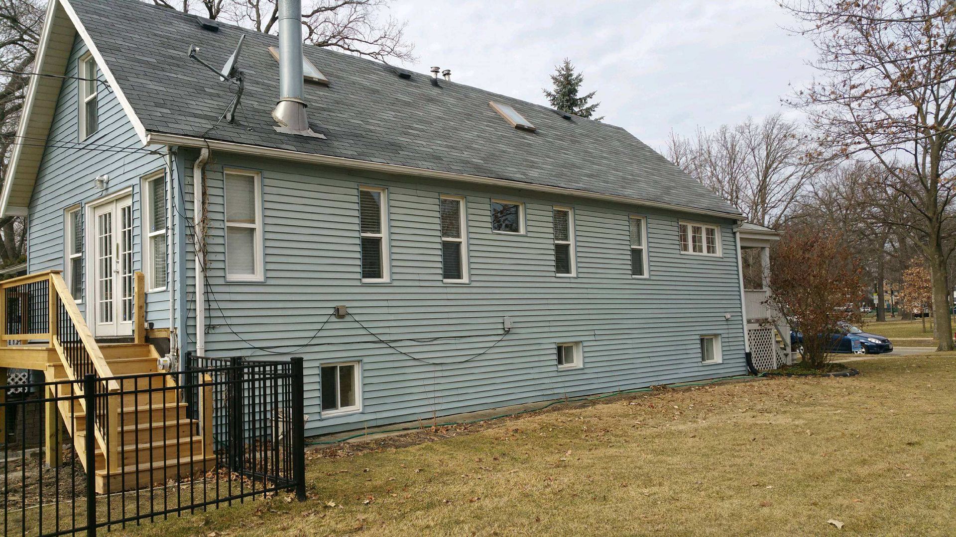 A large white house with a black fence in front of it.