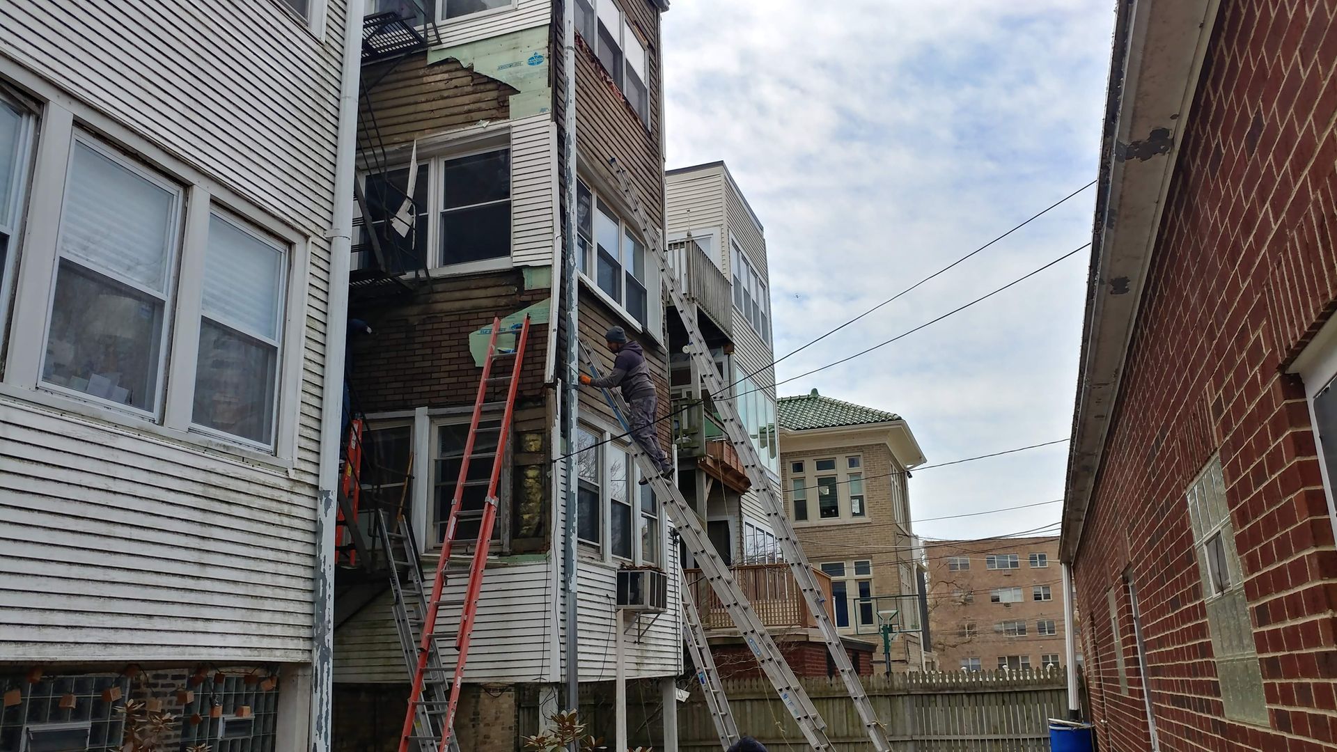 A fire escape is being built on the side of a building.
