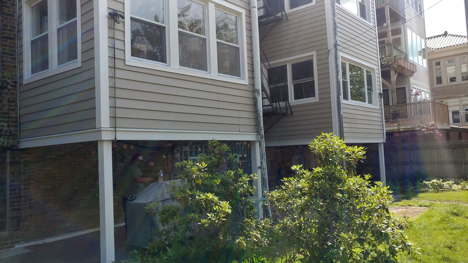 A building with a lot of windows and a tree in front of it.