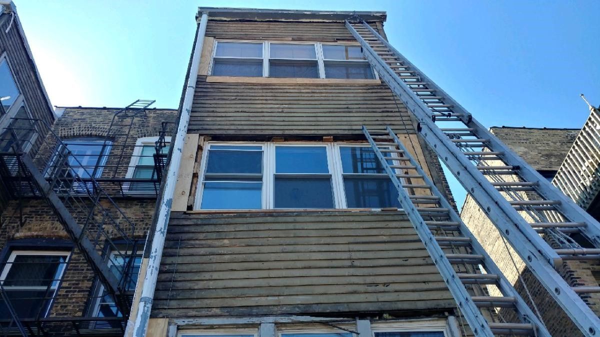 A ladder is attached to the side of a building.