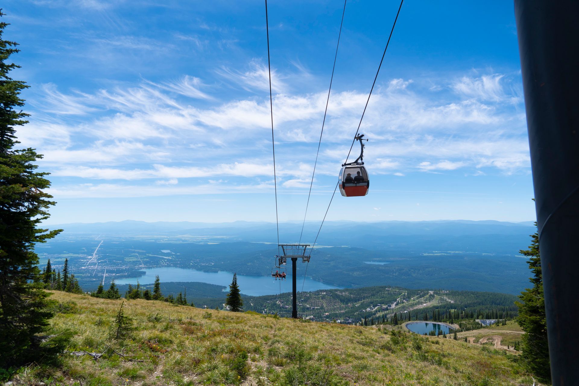 An aerial view of a ski resort surrounded by mountains and trees.