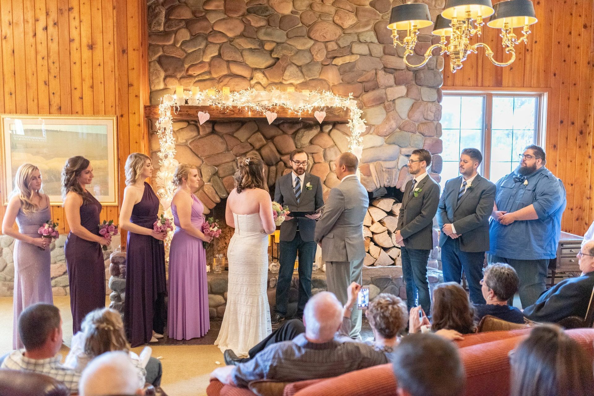 A bride and groom are getting married in front of a crowd of people.