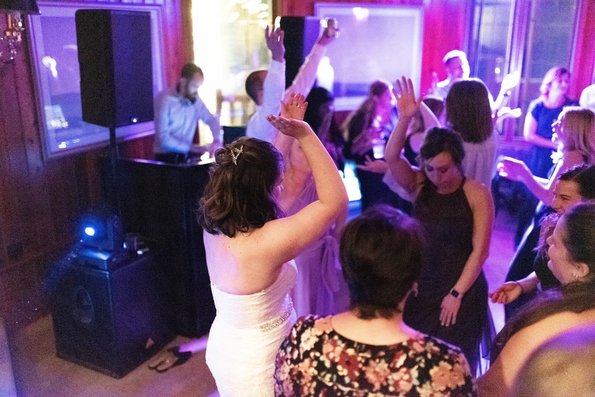 A group of people are dancing in a room at a party.