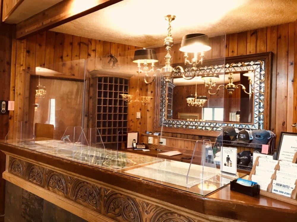 A hotel lobby with a counter and a mirror.