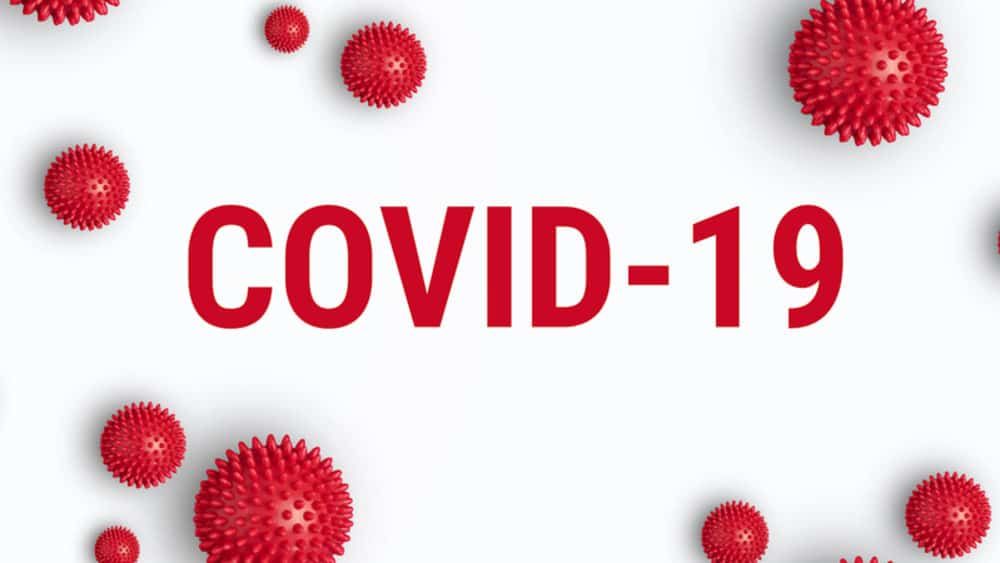 The word covid-19 is surrounded by red balls on a white background.