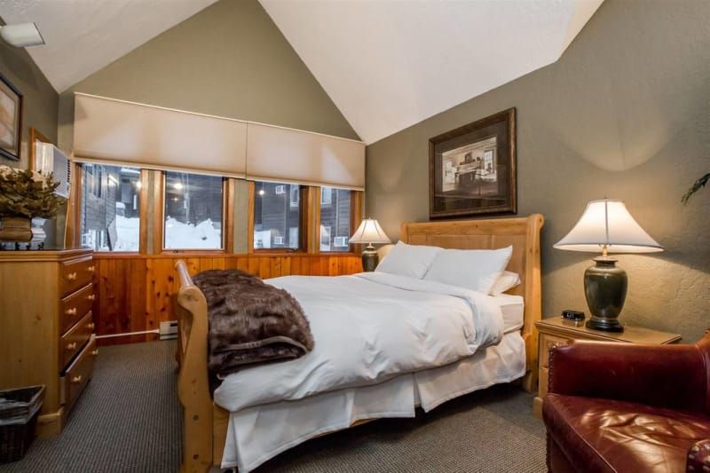 A bedroom with a king size bed and a chair