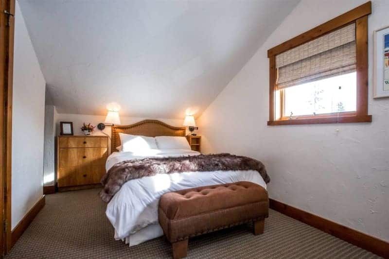 A bedroom with a king size bed and a window