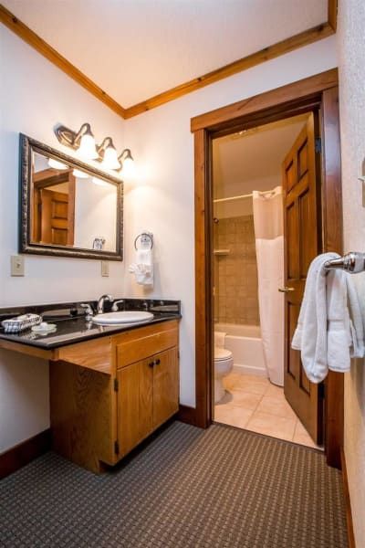 A bathroom with a sink a mirror and a toilet