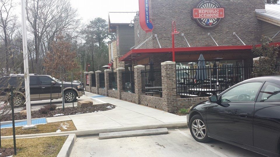 A car is parked in front of a restaurant that says open