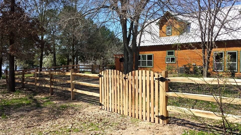 There is a wooden fence in front of a house.