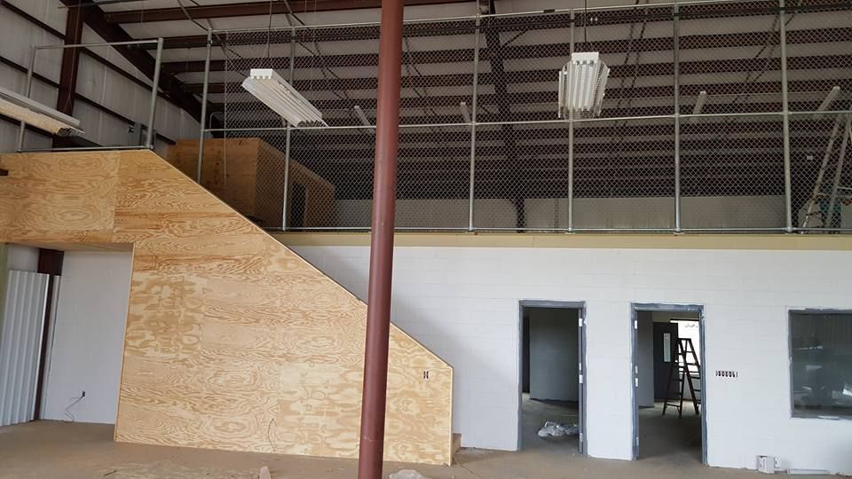 An empty building with stairs leading up to a second floor