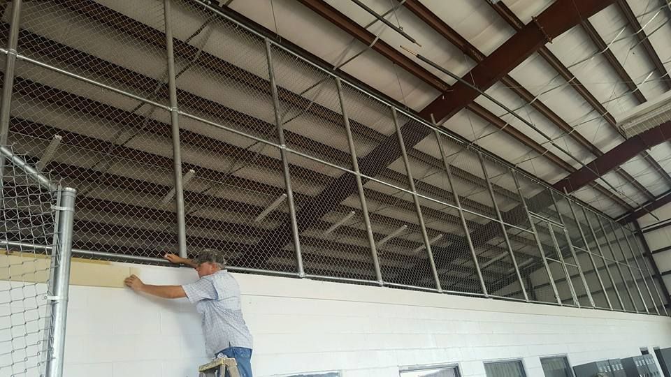 A man is working on a wall in a building