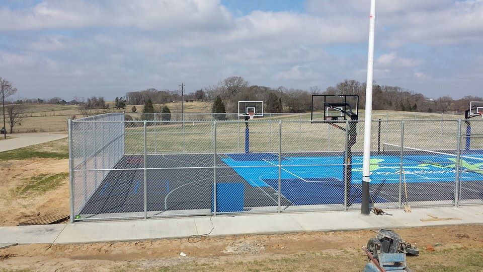 A basketball court with a chain link fence around it