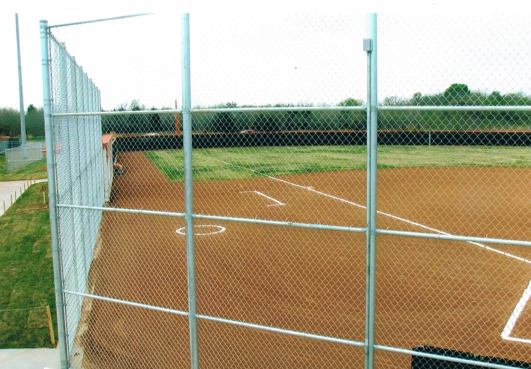 A baseball field with a chain link fence surrounding it