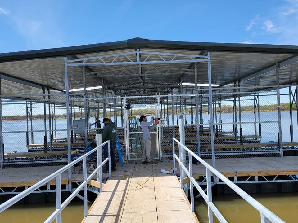 A group of people are working on a dock on a lake.