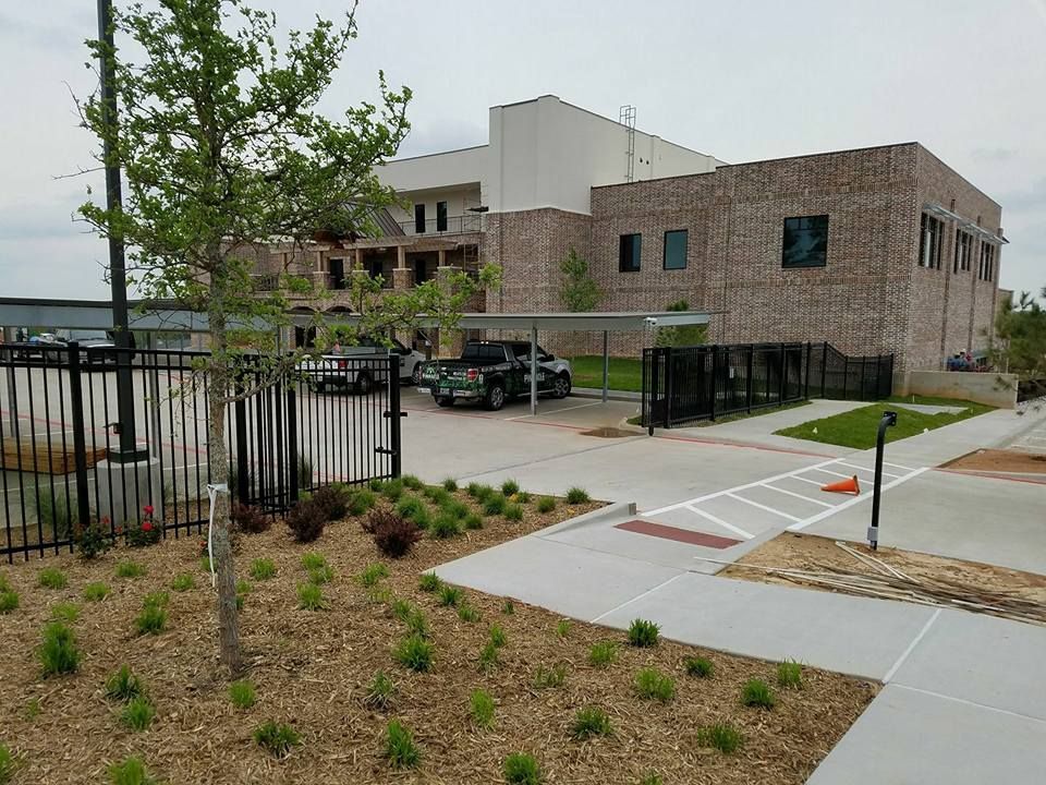 A large brick building with a parking lot in front of it.