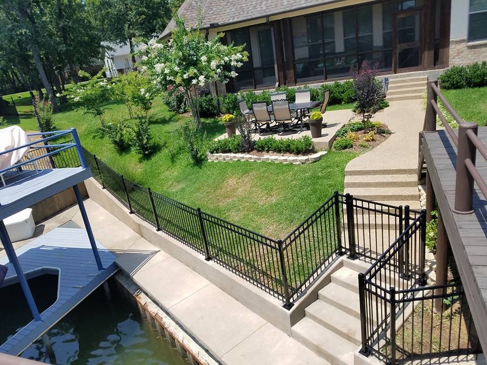A house with a fence around it and stairs leading to it.