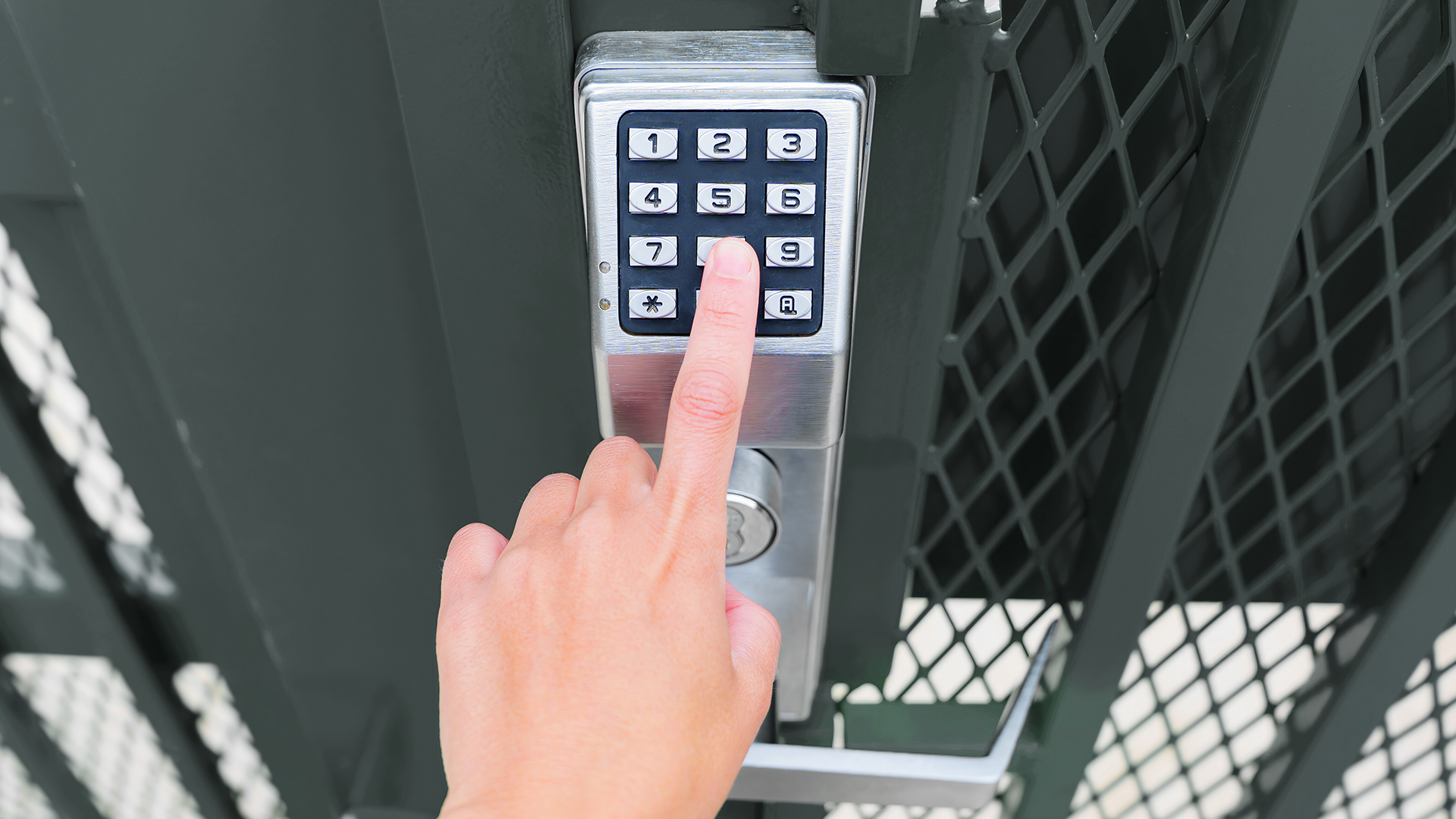 A person is pressing a button on a keypad.