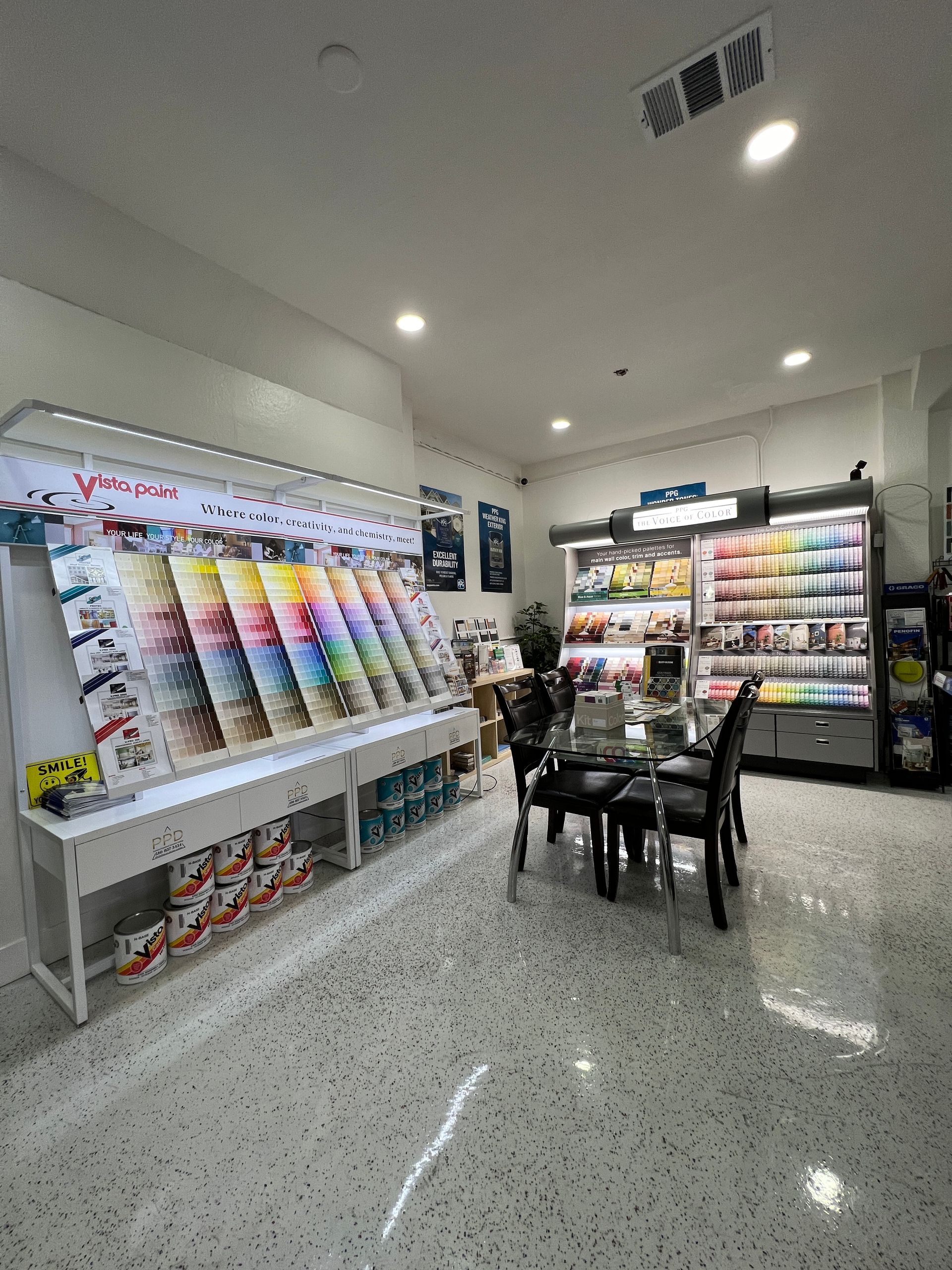 A dining room with a table and chairs in a paint store.