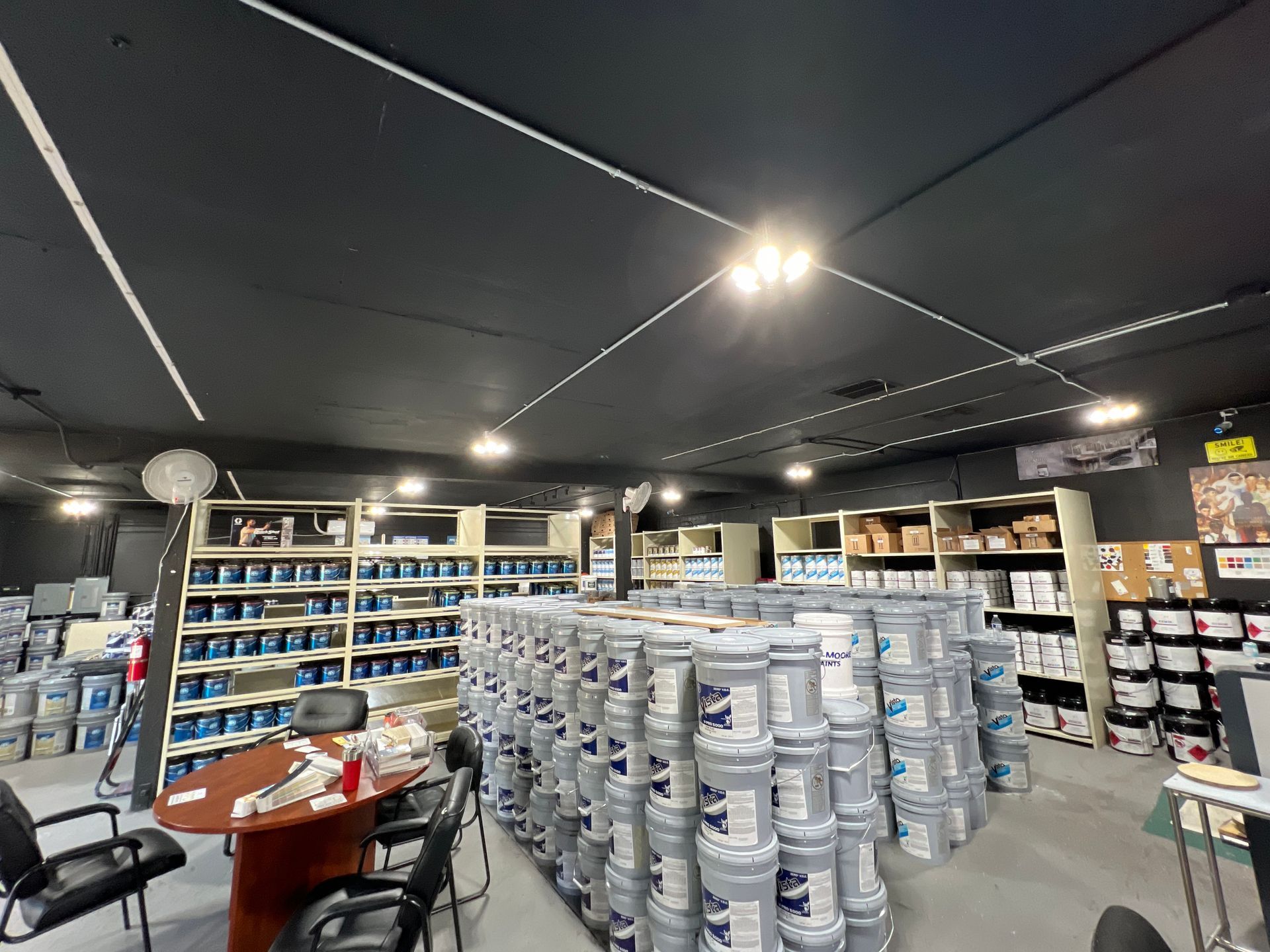 A large room filled with lots of buckets of paint.