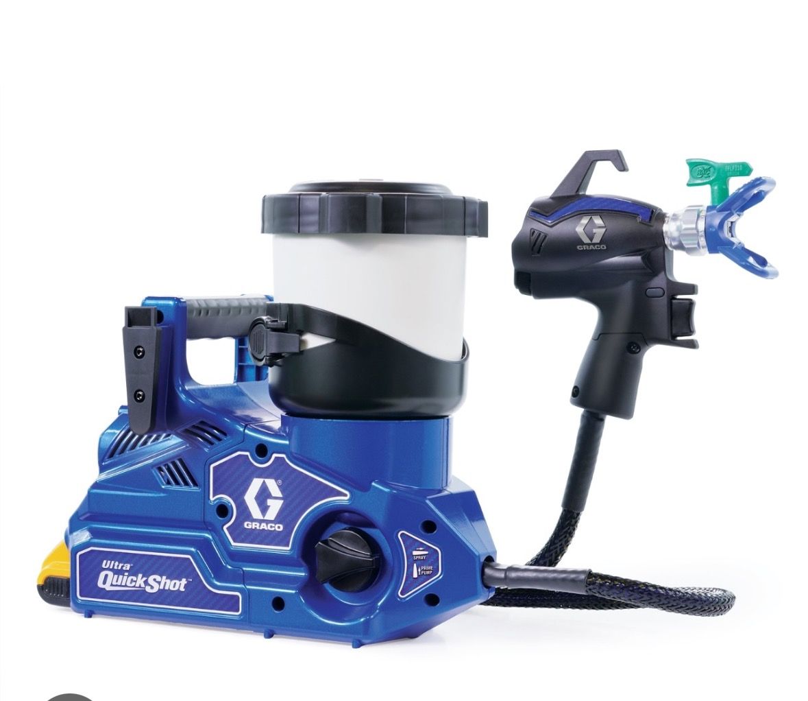 A blue and black paint sprayer is sitting on a white surface.