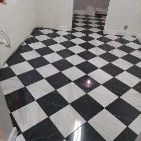Black and white checkered tile floor in a room.