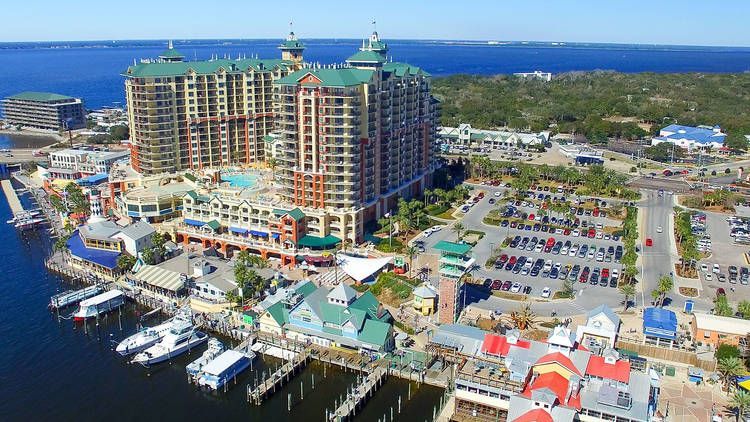 An aerial view of a large building next to a body of water.
