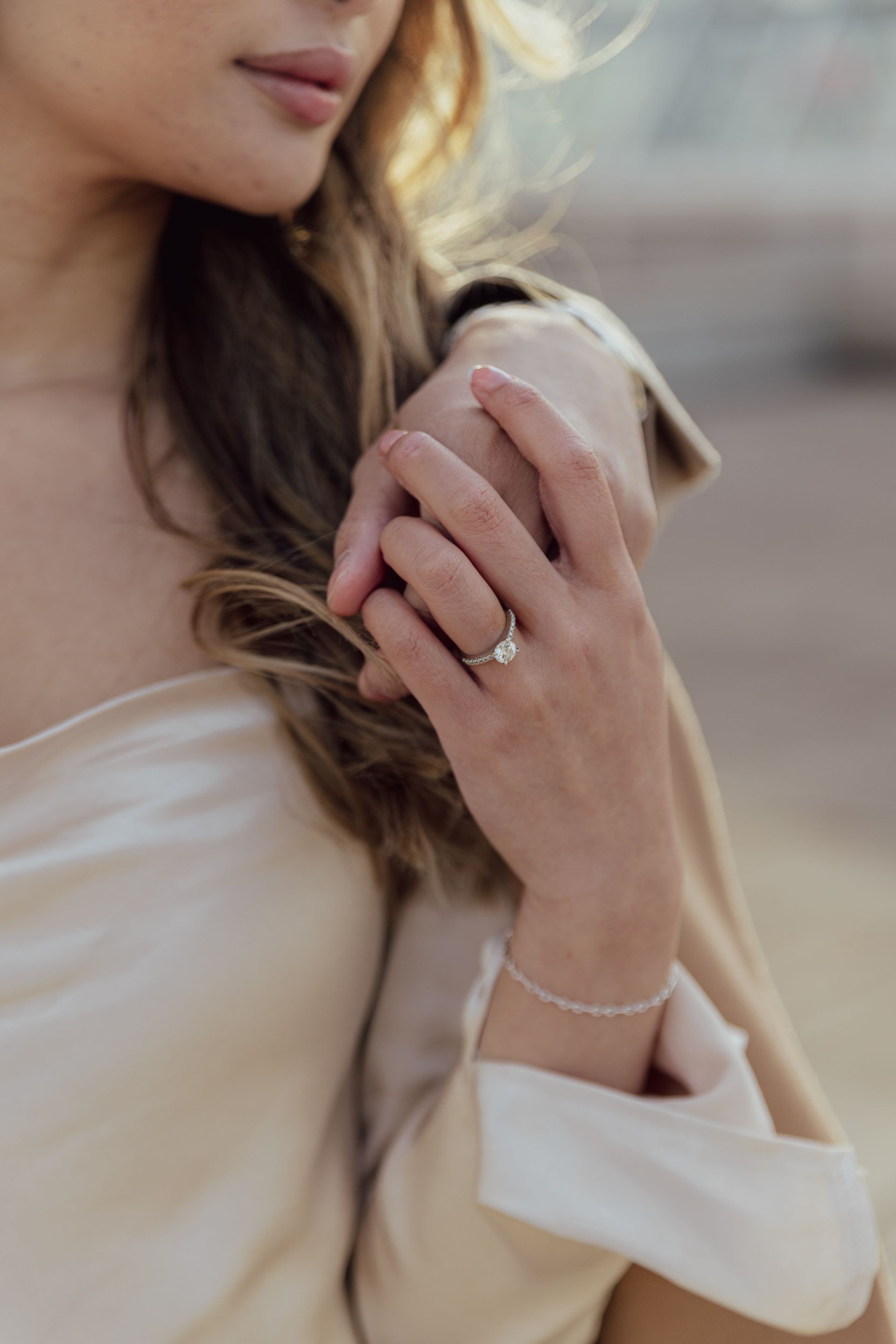 A close up of a woman 's hand with a ring on it.
