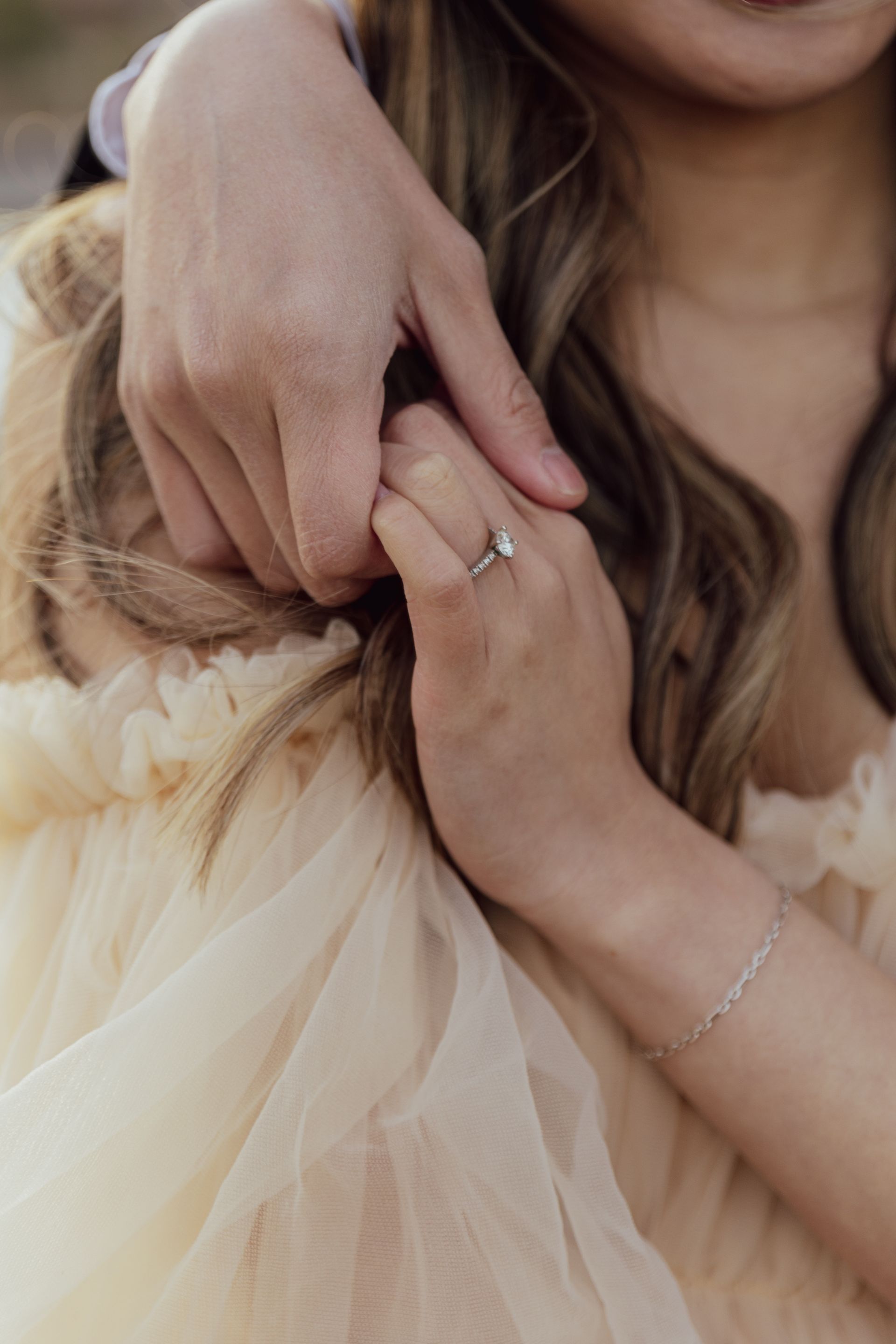 A close up of a woman 's hand with a ring on it.