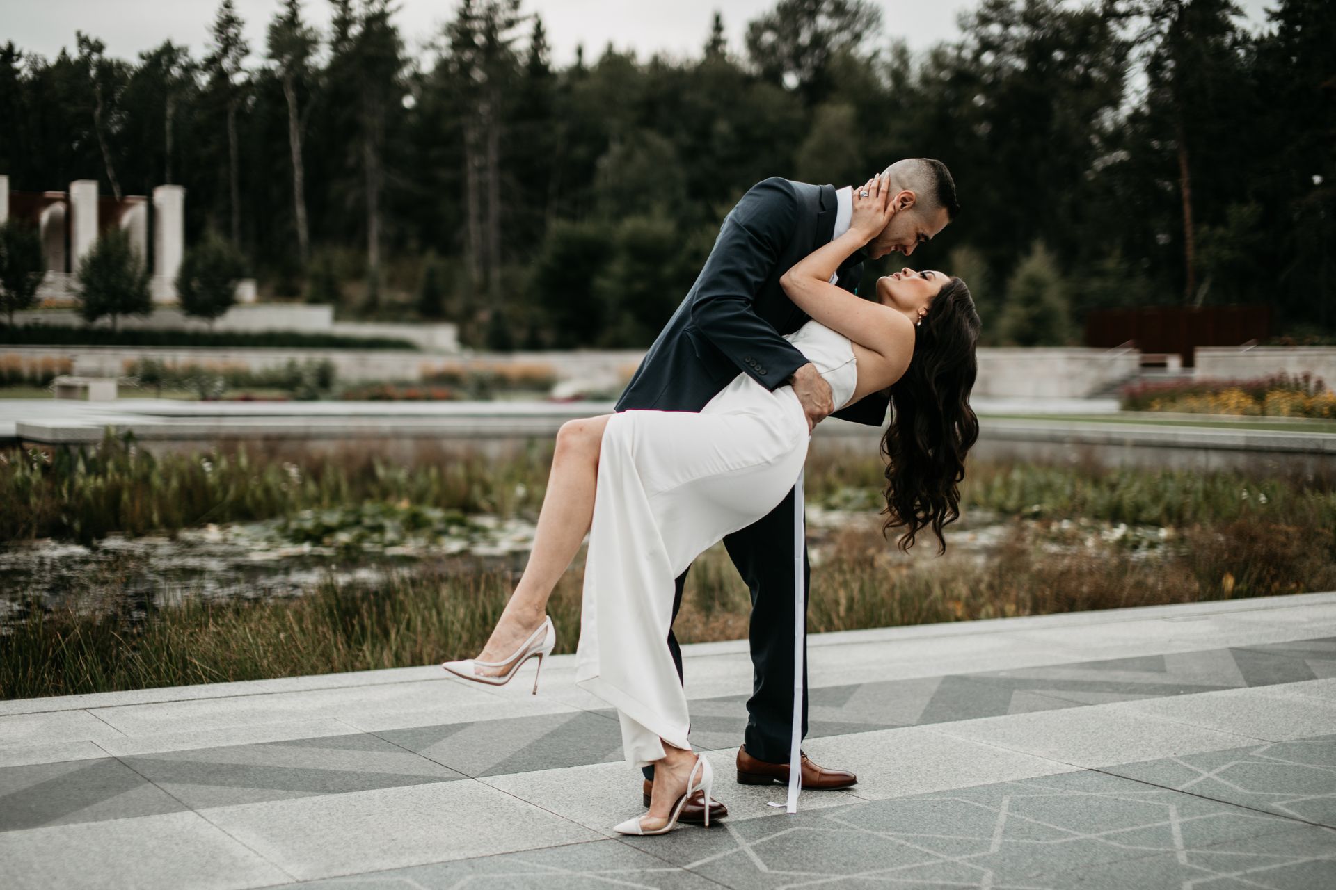 A man is holding a woman in his arms and kissing her.