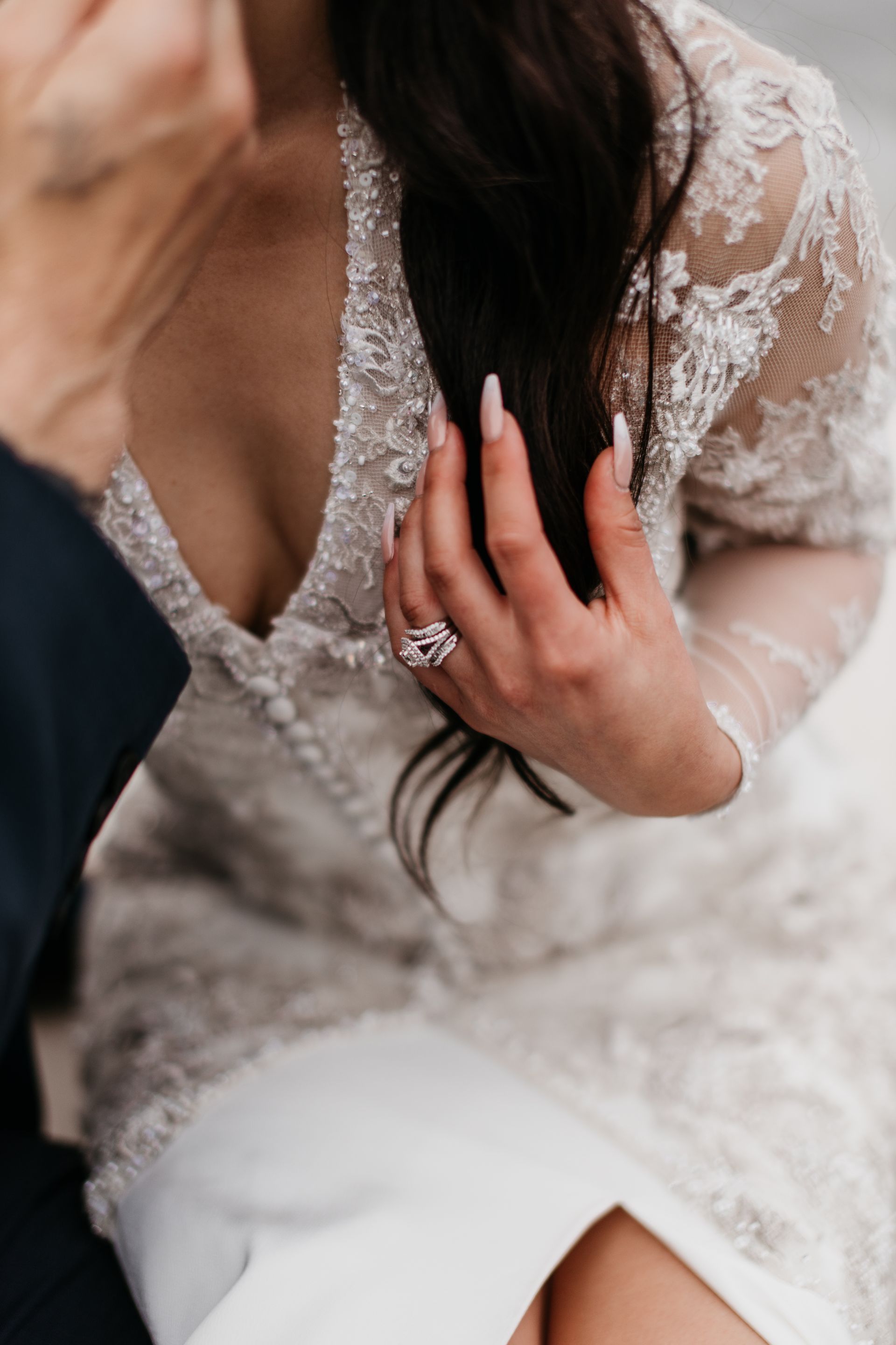 A close up of a woman 's hand with a ring on it.