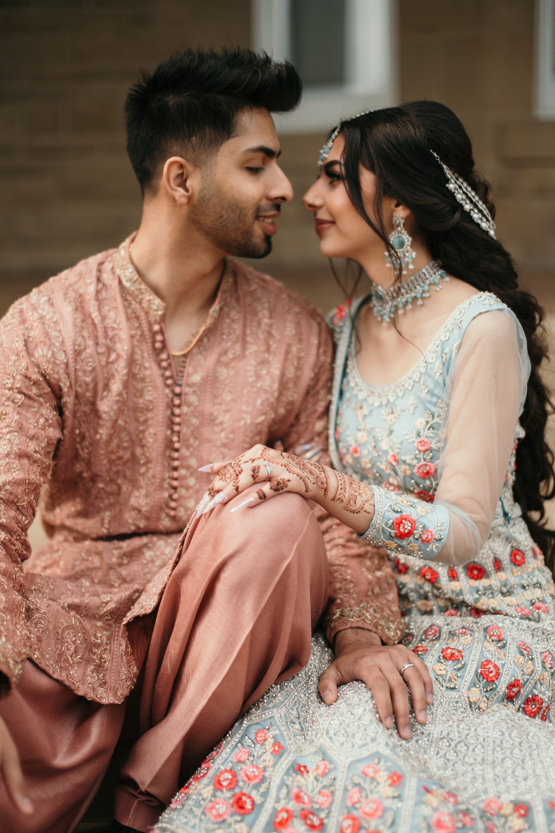 A man and a woman are sitting next to each other and looking at each other.