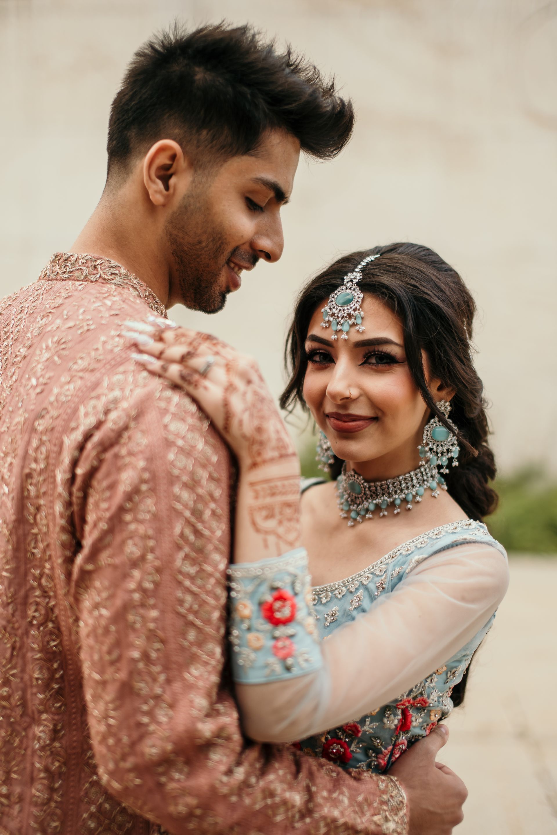 A man and a woman are standing next to each other and hugging.