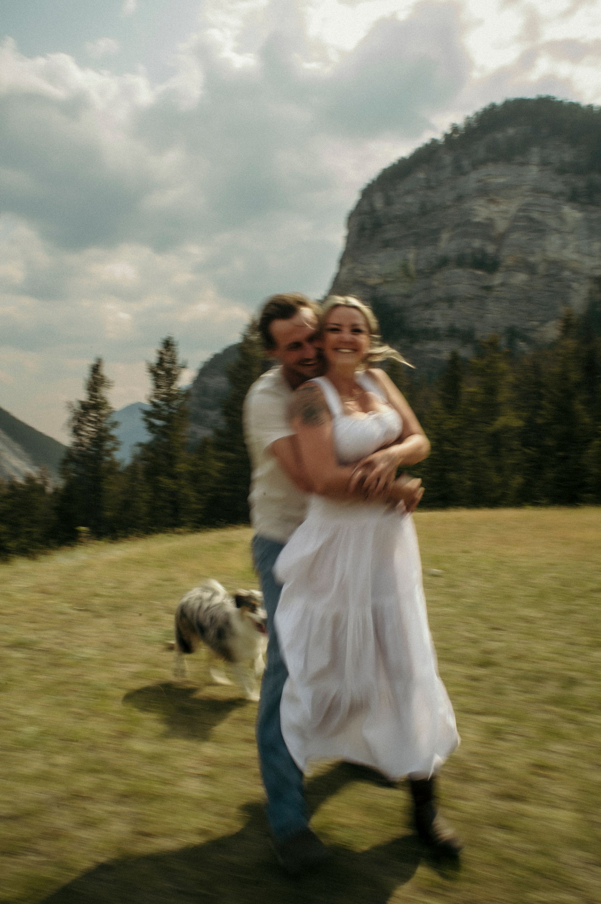 Two men are looking at a screen in a black and white photo.