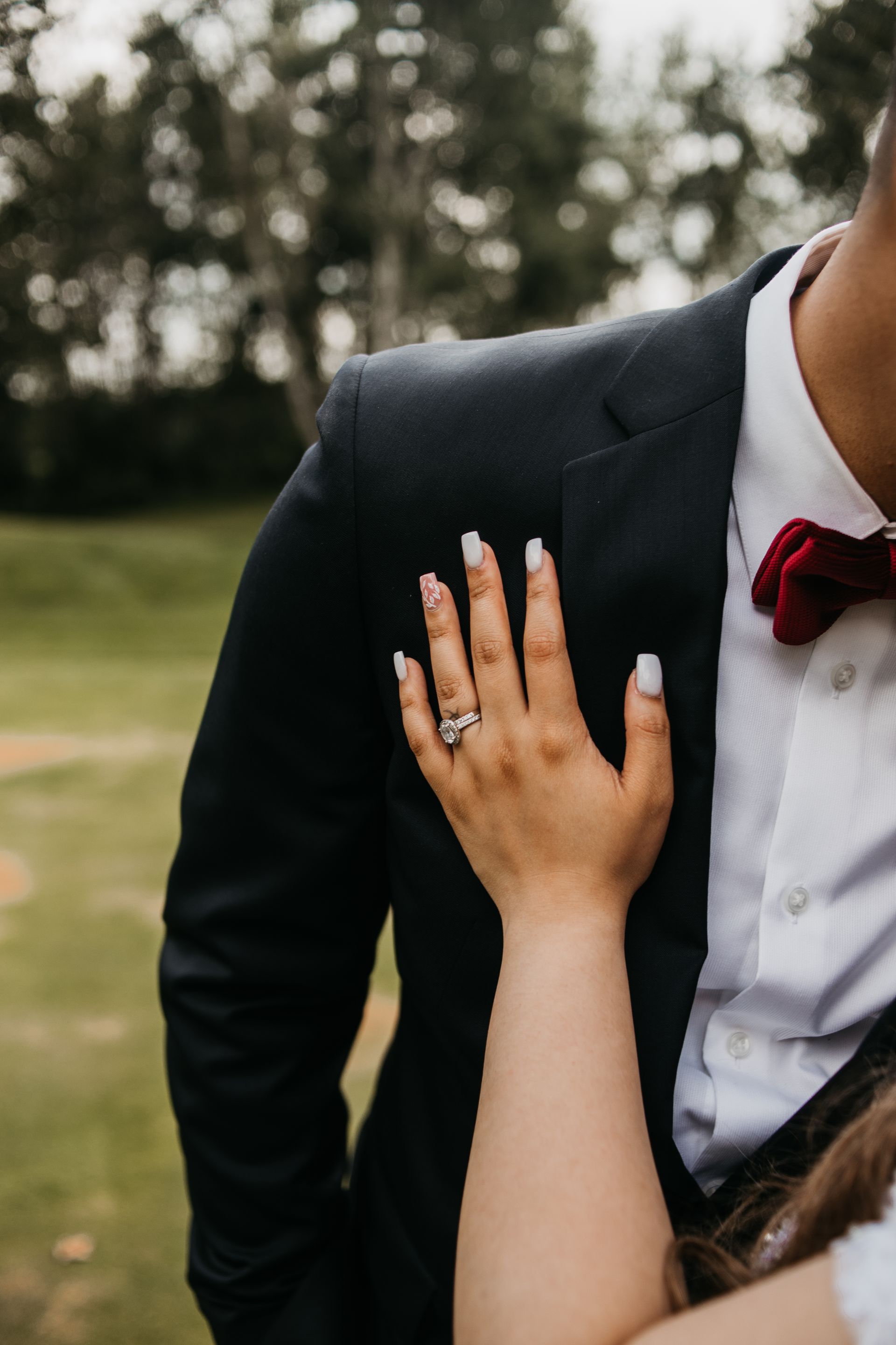 A woman is putting her hand on a man 's chest.