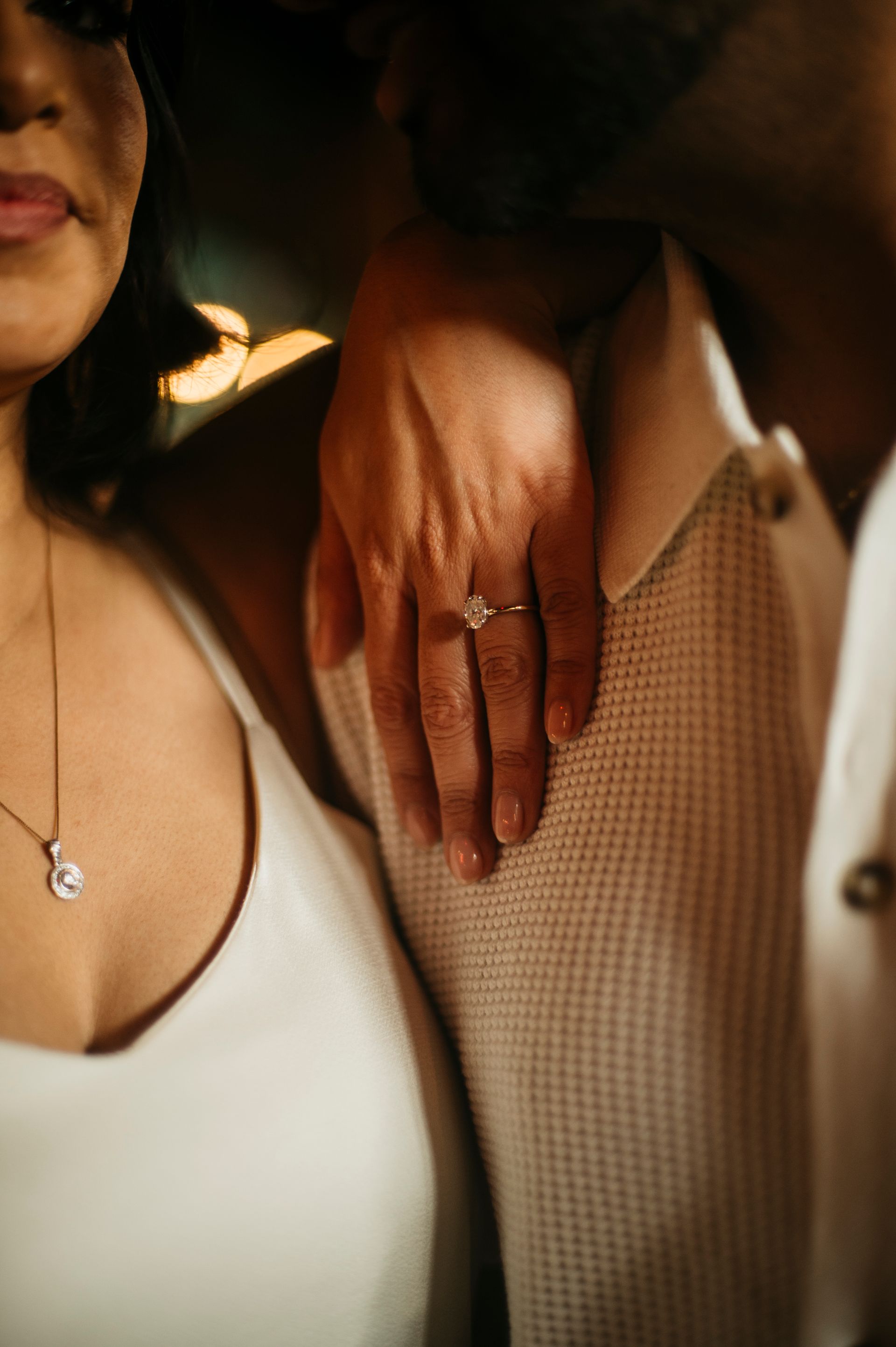 Two women wearing fur coats are standing next to each other on a rooftop.