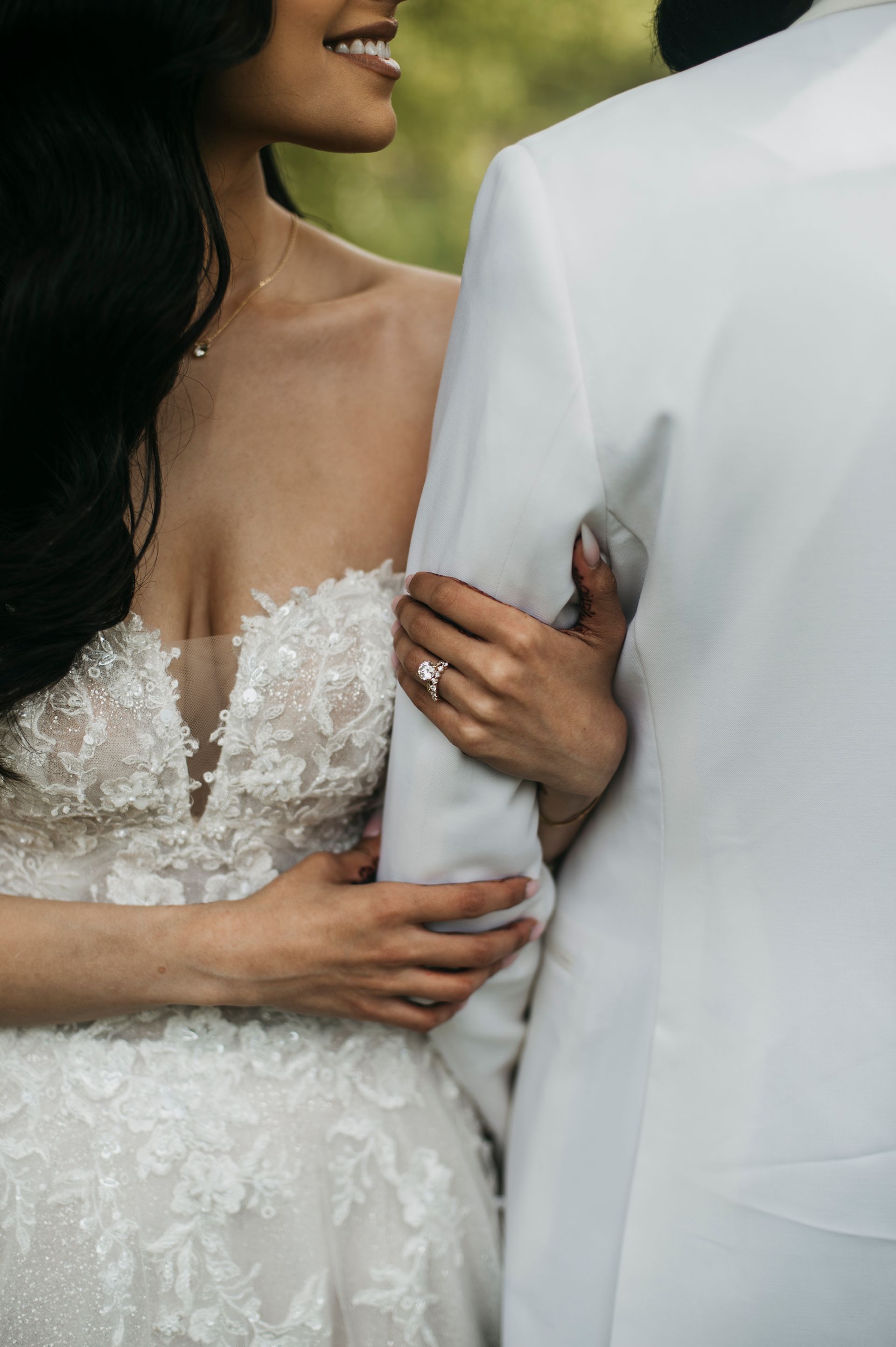 The bride is wearing a wedding dress and the groom is wearing a tuxedo.