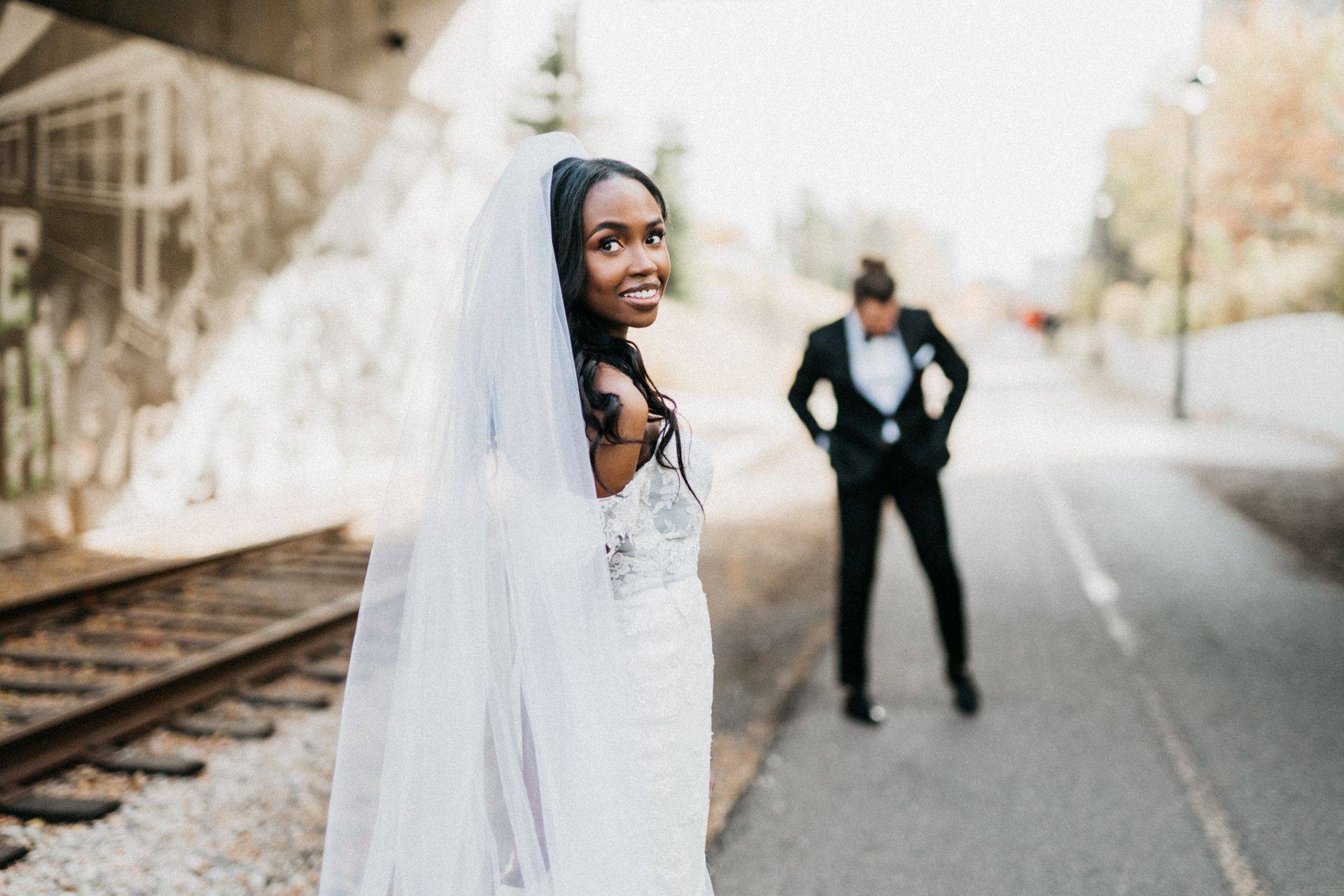 A bride and groom are posing for a picture on their wedding day.