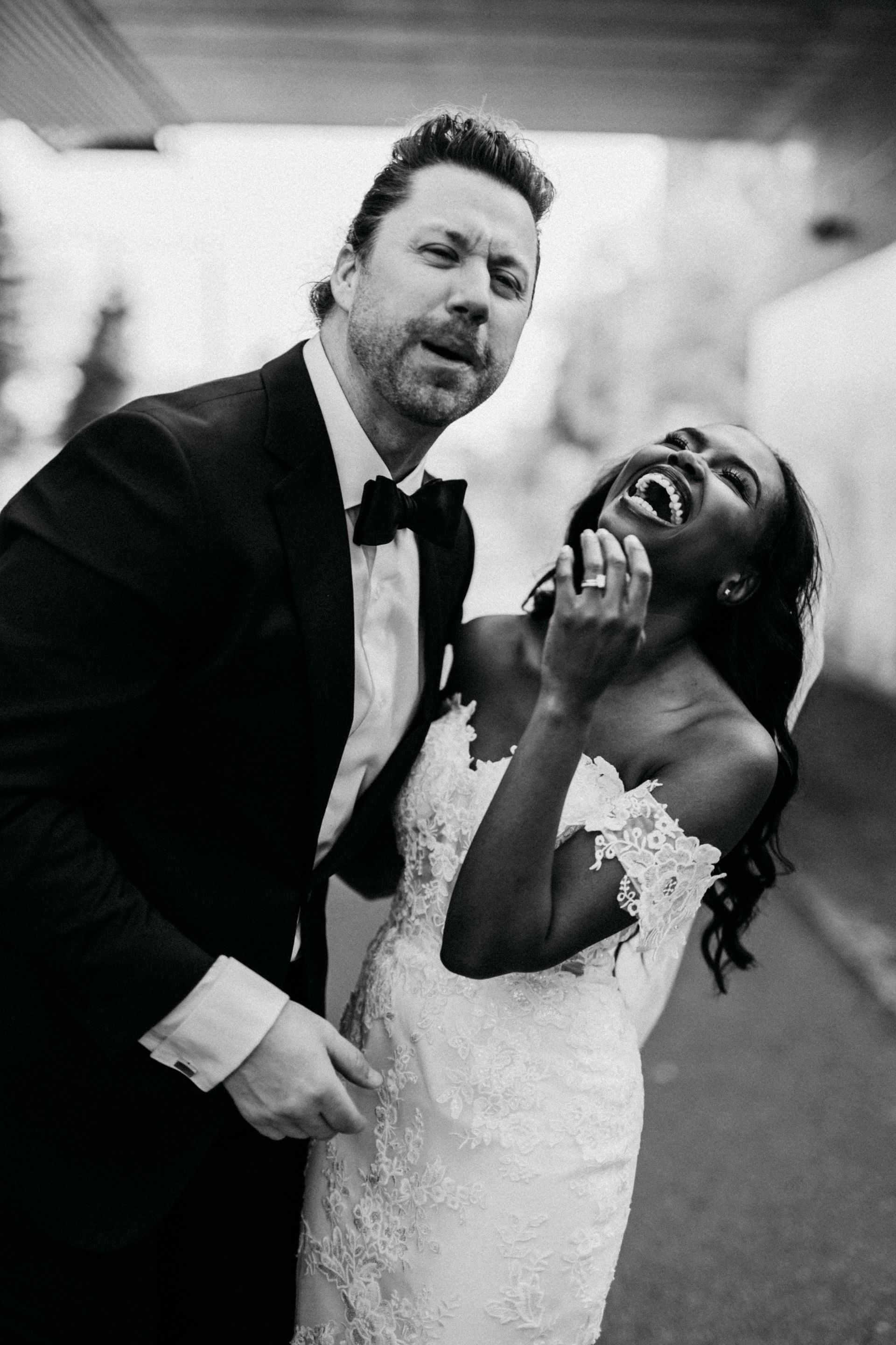 A black and white photo of a bride and groom posing for a picture.